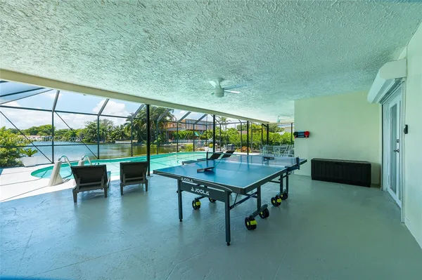 a room with pool table and windows