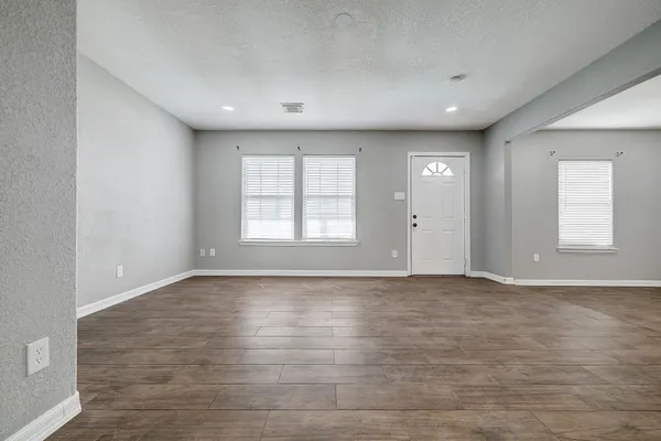 a view of an empty room with a window