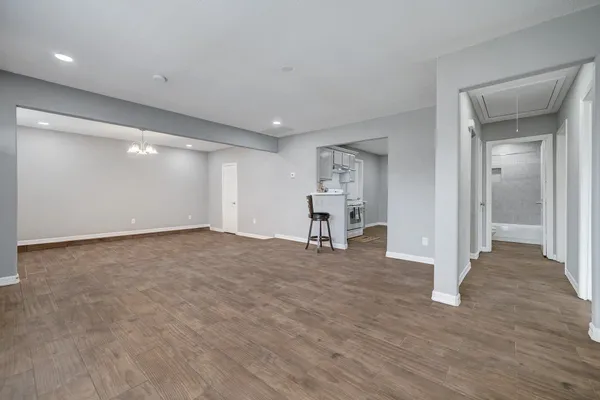 a kitchen with granite countertop a sink a stove and cabinets