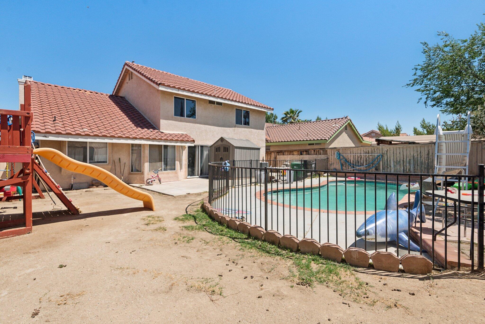 37151 Daisy Street Palmdale, CA 93550 - Photo 13 of 14 a view of a house with wooden fence