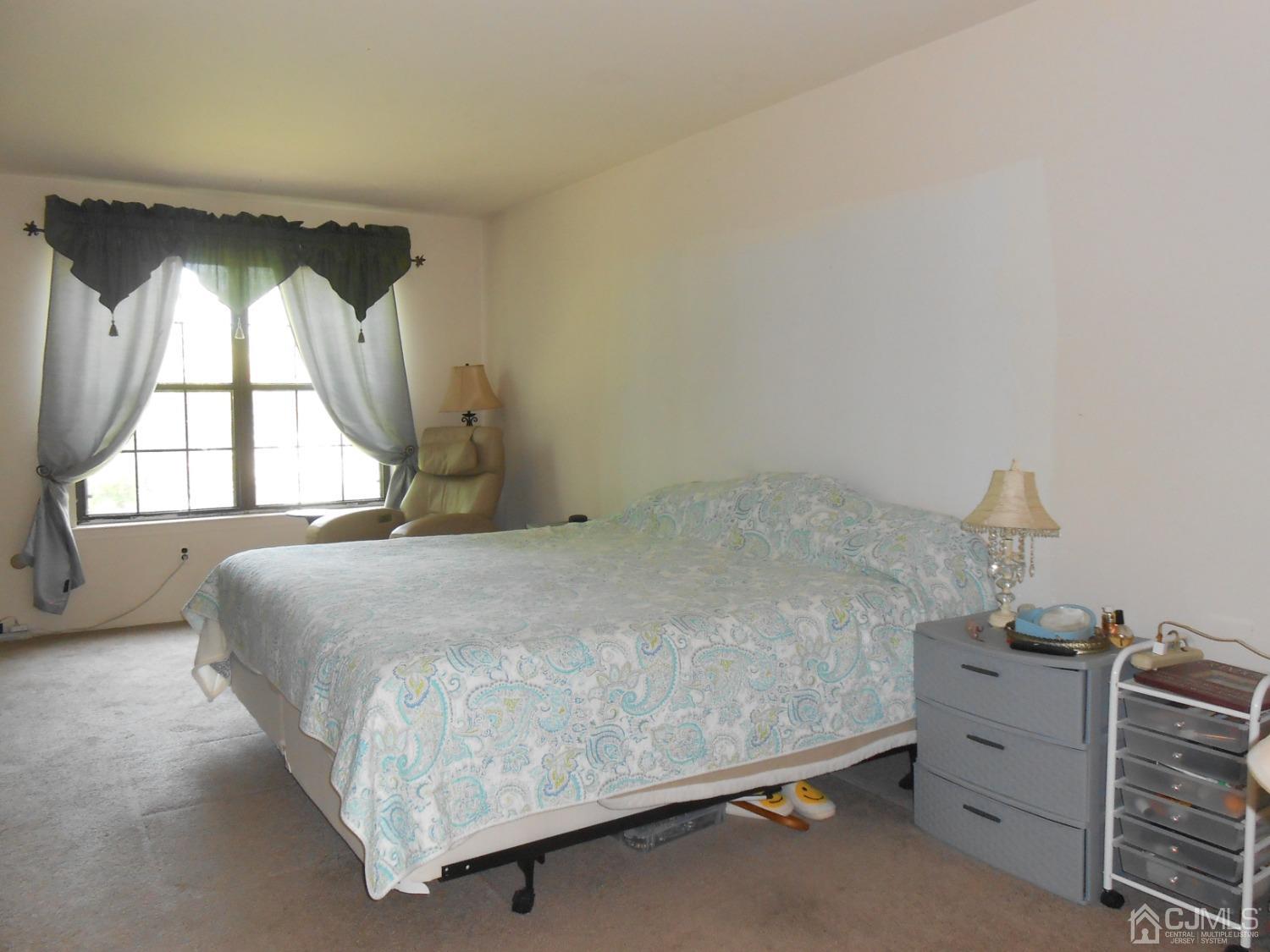 93 Pheasant Run Edison, NJ 08820 - Photo 14 of 24 a bedroom with a bed and window