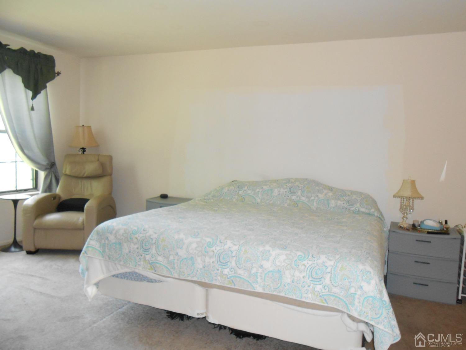 93 Pheasant Run Edison, NJ 08820 - Photo 15 of 24 a bedroom with a bed and a couch