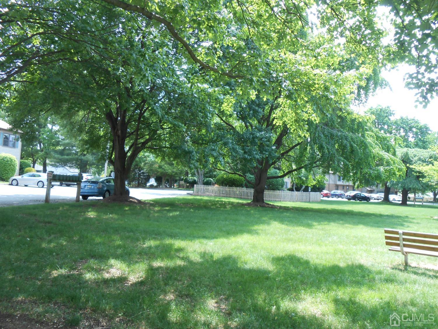 93 Pheasant Run Edison, NJ 08820 - Photo 21 of 24 a view of a park with trees in the background