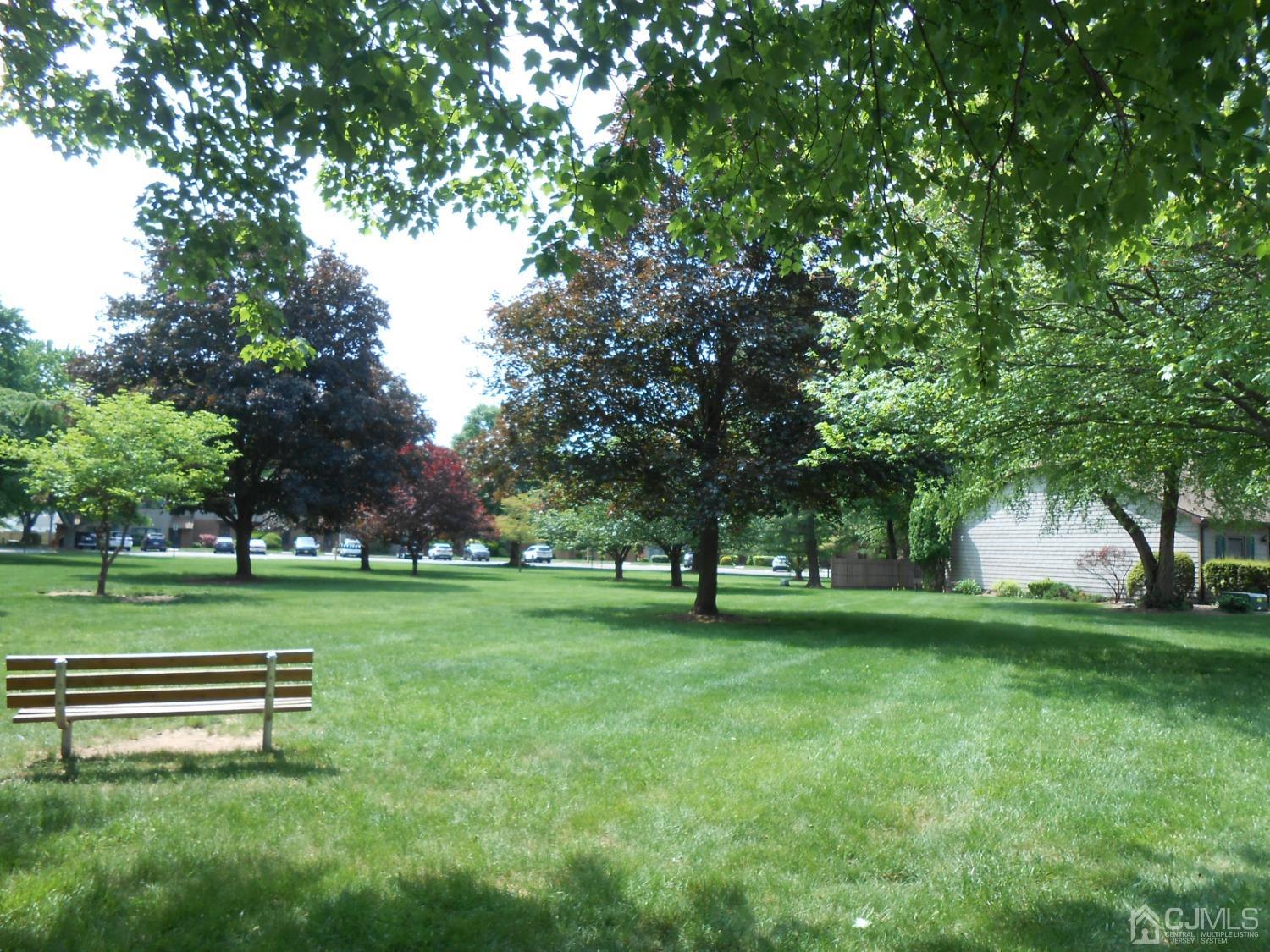 93 Pheasant Run Edison, NJ 08820 - Photo 23 of 24 a view of a park with trees and wooden fence