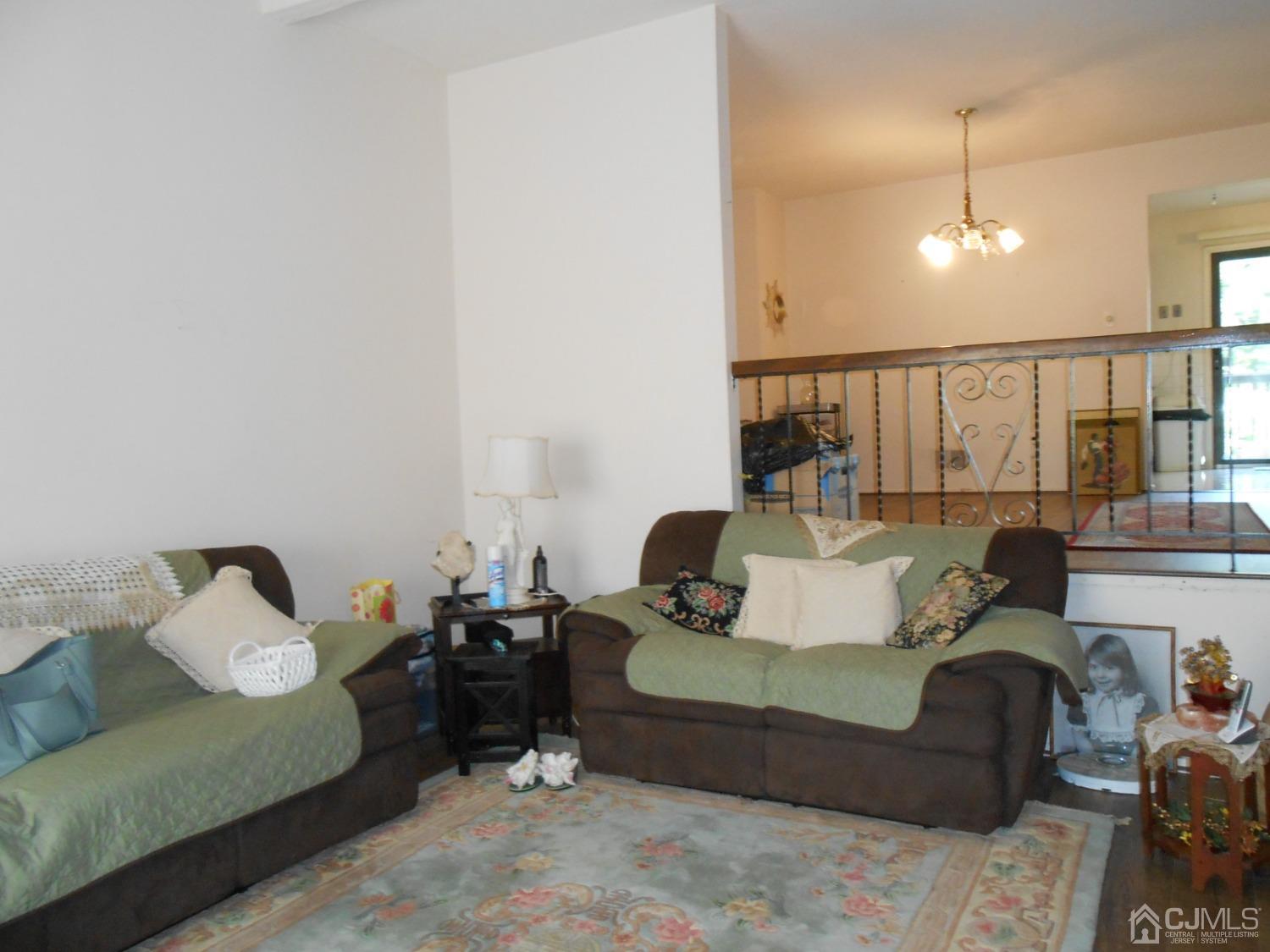93 Pheasant Run Edison, NJ 08820 - Photo 3 of 24 a living room with furniture and wooden floor