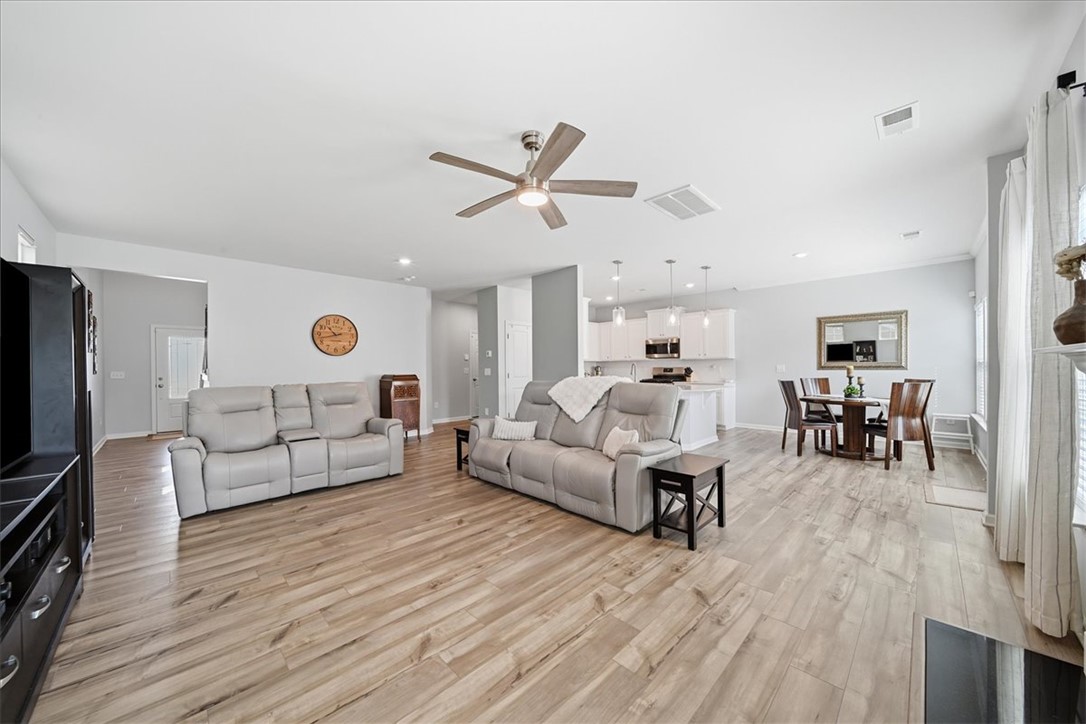 208 Grassy Creek Way Pendleton, SC 29670 - Photo 7 of 43 An open-concept main living area flows seamlessly with resilient wood-look flooring and a contemporary kitchen beyond.