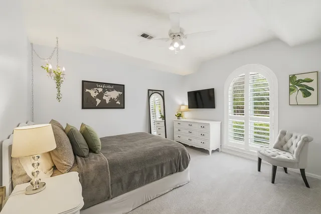 a bedroom with a bed and ceiling fan
