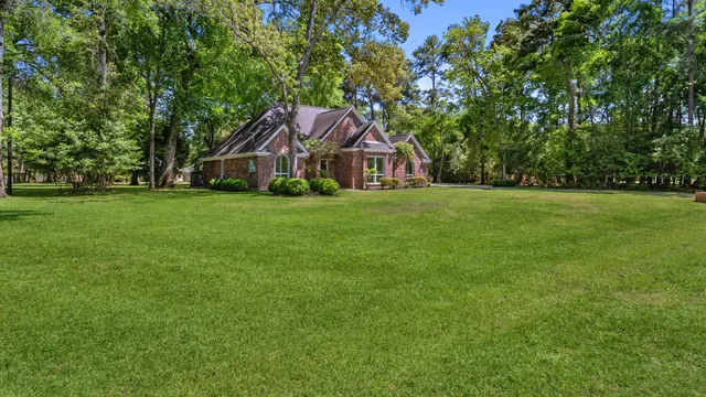 a front view of a house with yard and green space