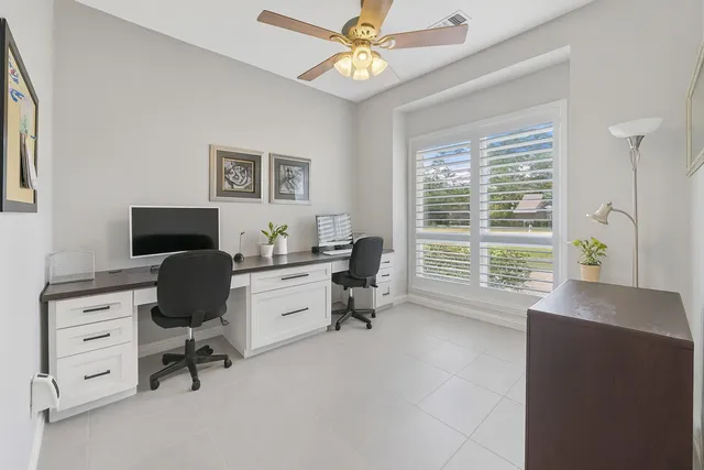 a view of a hallway with bathroom and a shower