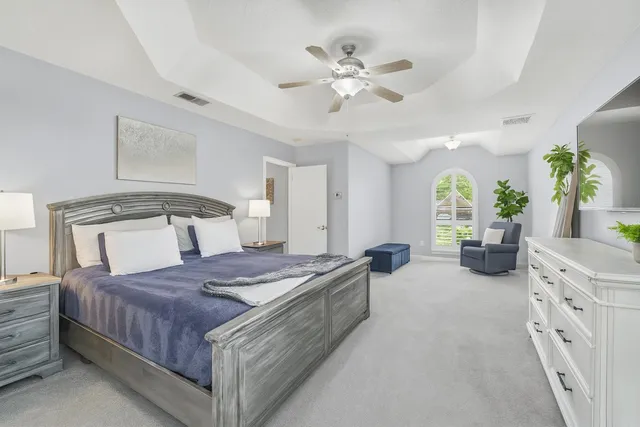 a view of a house with a big yard and large trees