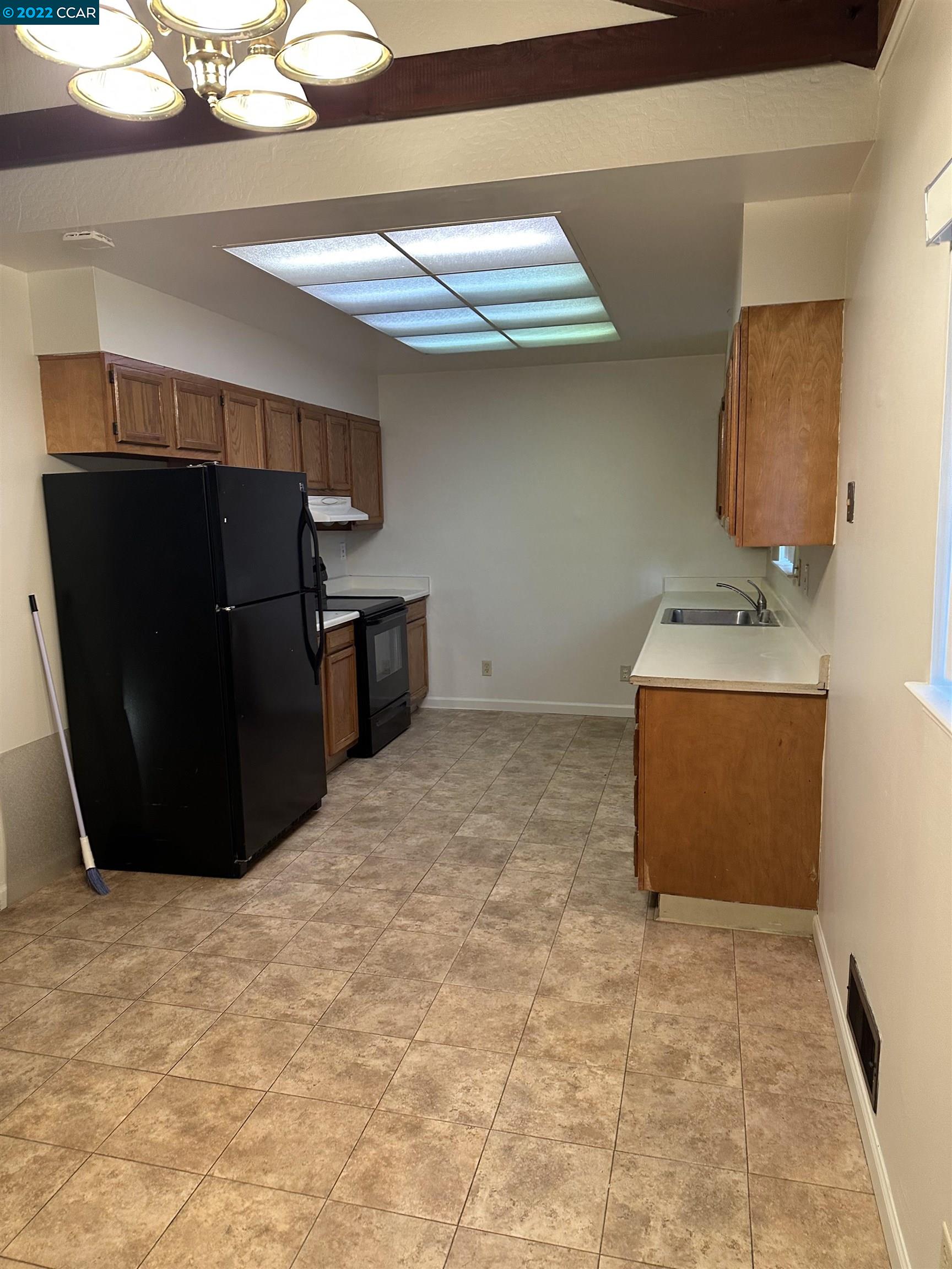 2715 Cowell Road Concord, CA 94518 - Photo 3 of 5 a room with a refrigerator and a sink