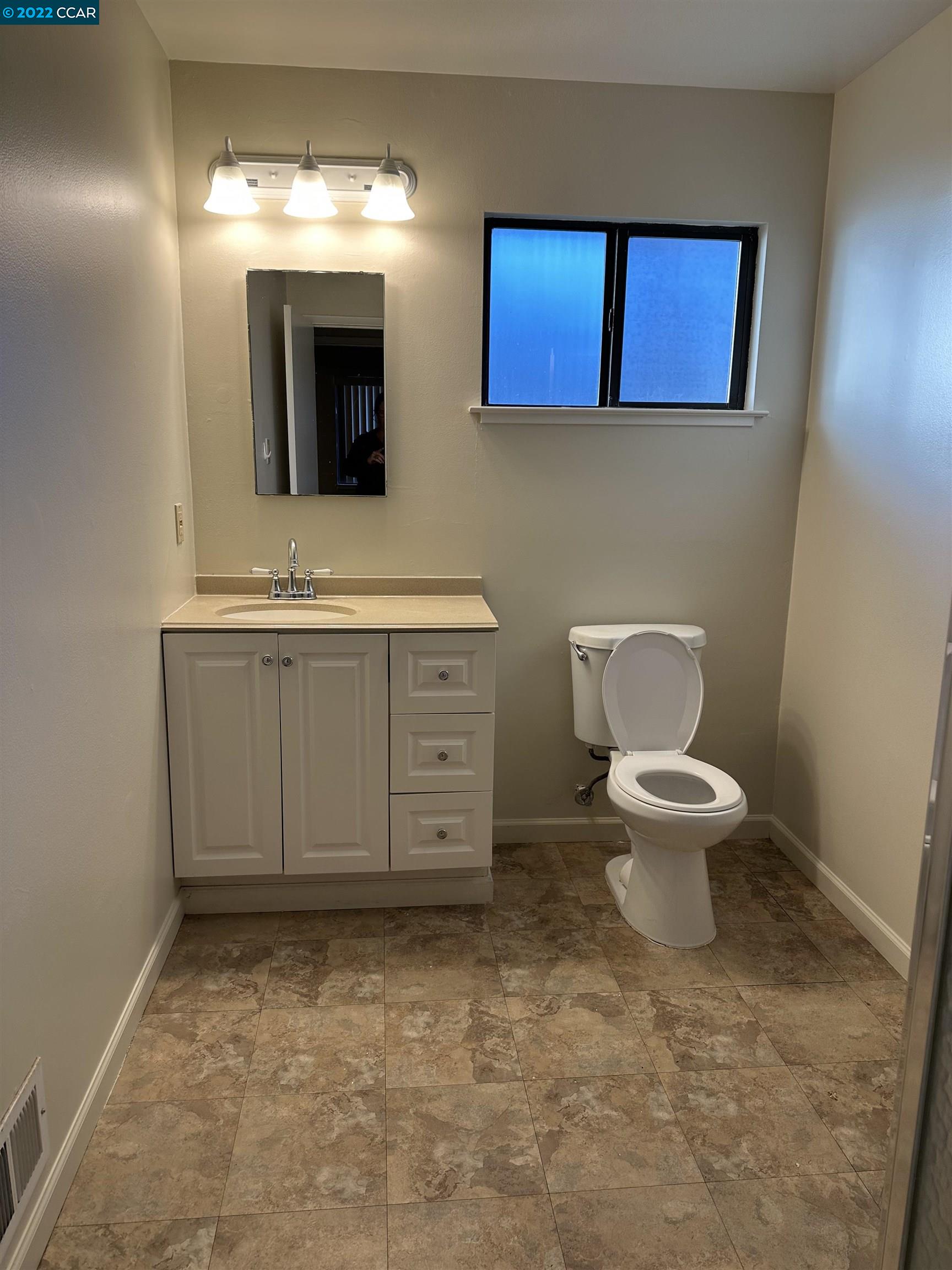 2715 Cowell Road Concord, CA 94518 - Photo 5 of 5 a bathroom with a toilet sink and mirror