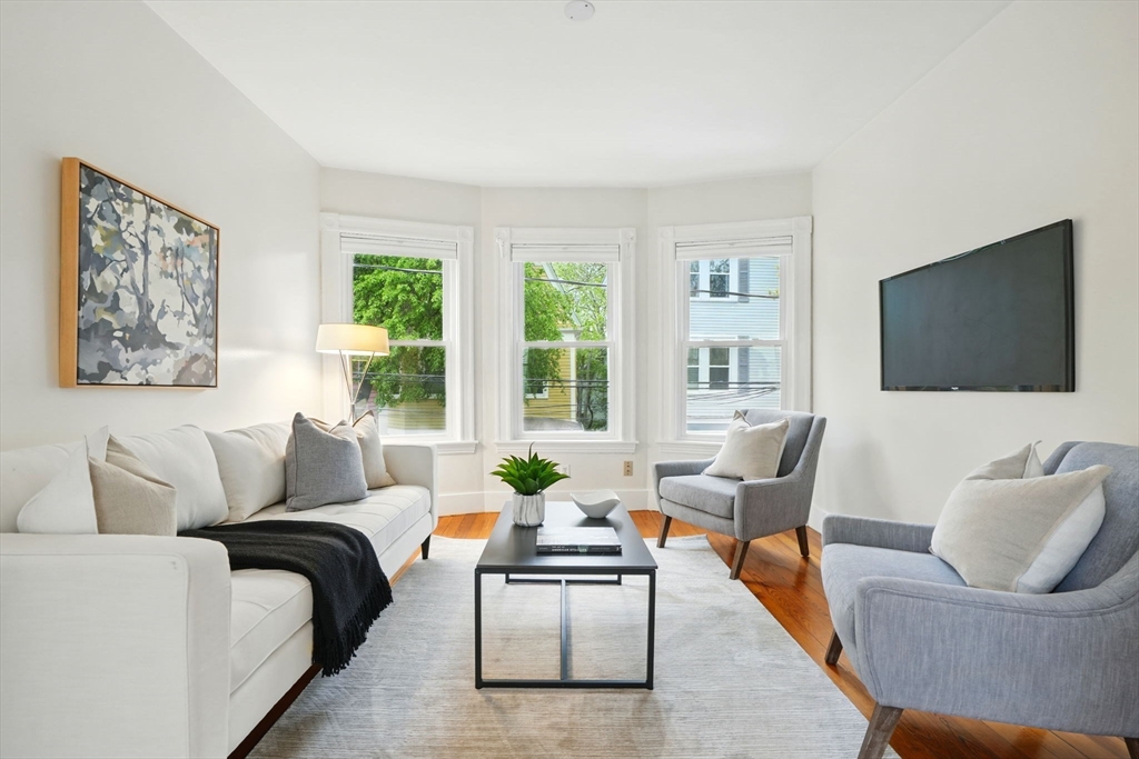 65 Eustis Street, Unit 2 Cambridge, MA 02140 - Photo 1 of 11 a living room with furniture and a flat screen tv
