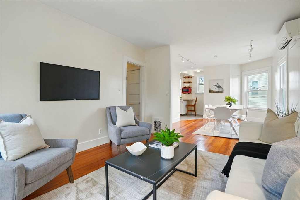 65 Eustis Street, Unit 2 Cambridge, MA 02140 - Photo 2 of 11 a living room with furniture and a flat screen tv