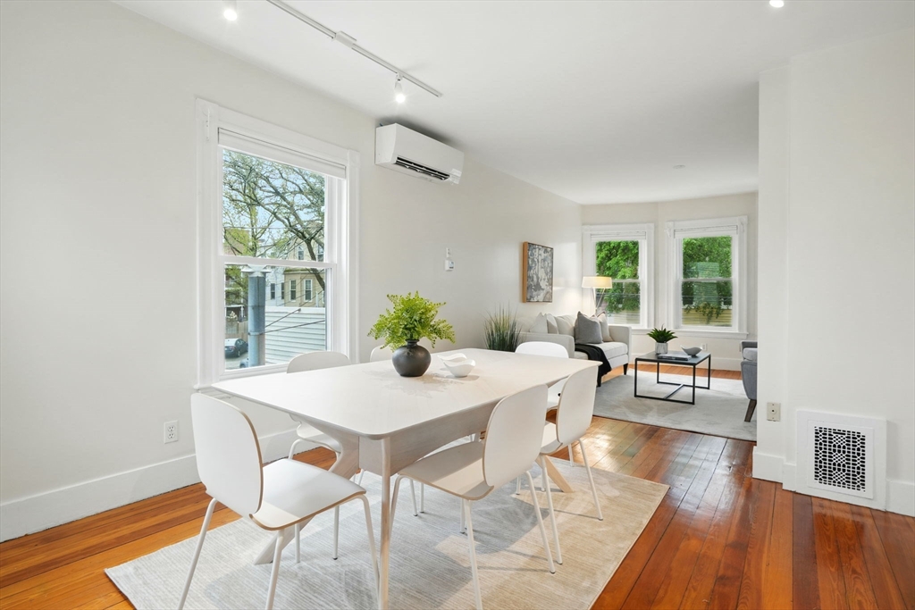 65 Eustis Street, Unit 2 Cambridge, MA 02140 - Photo 3 of 11 a view of a dining room with furniture and wooden floor