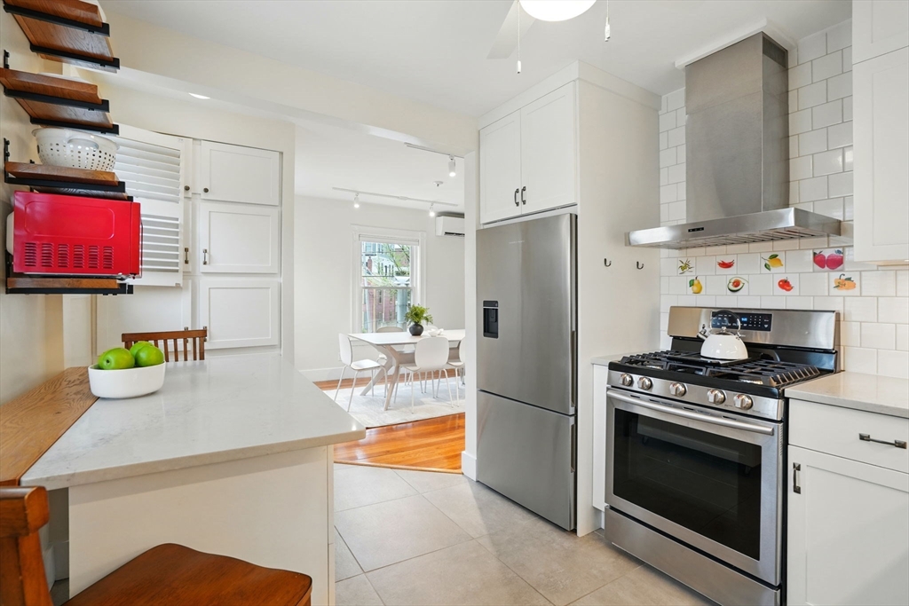 65 Eustis Street, Unit 2 Cambridge, MA 02140 - Photo 6 of 11 a kitchen with stainless steel appliances a stove a sink and a refrigerator