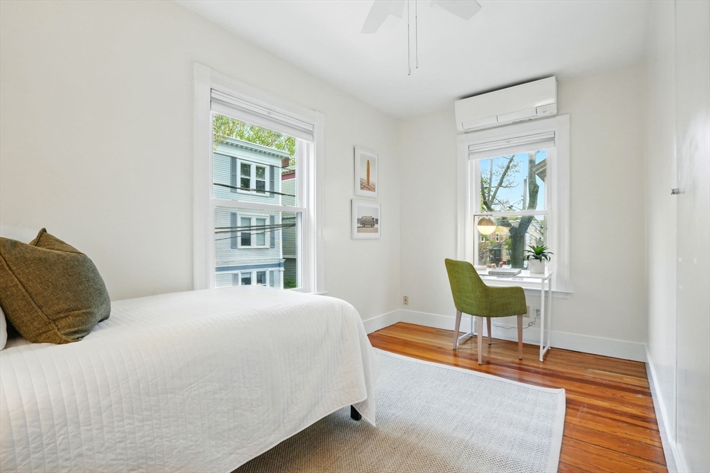 65 Eustis Street, Unit 2 Cambridge, MA 02140 - Photo 9 of 11 a bedroom with a bed and a table