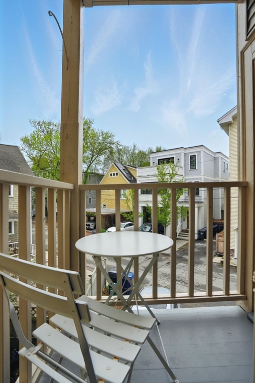 65 Eustis Street, Unit 2 Cambridge, MA 02140 - Photo 10 of 11 a view of a balcony with table and chairs