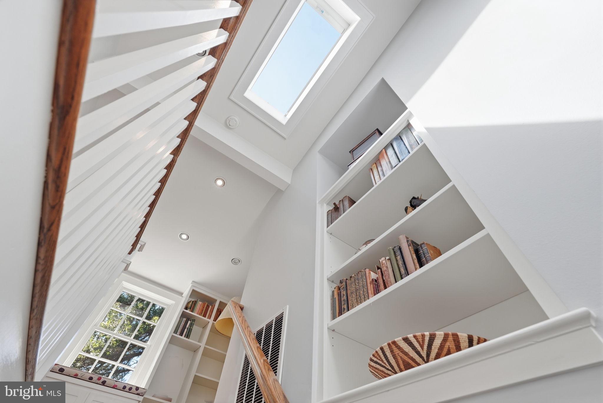 6814 Brookville Road Chevy Chase, MD 20815 - Photo 24 of 39 Bright and airy staircase with bookshelves.