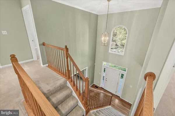 a large kitchen with stainless steel appliances granite countertop a stove top oven a sink dishwasher a dining table and chairs with wooden floor