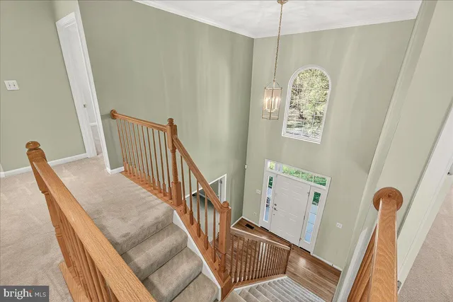 a large kitchen with stainless steel appliances granite countertop a stove top oven a sink dishwasher a dining table and chairs with wooden floor