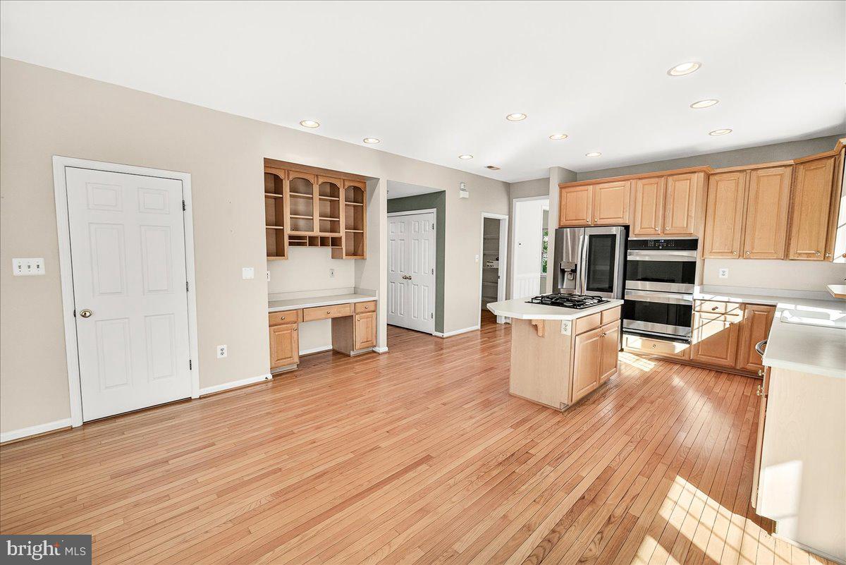 19332 Cissel Manor Drive Poolesville, MD 20837 - Photo 27 of 81 a kitchen with stainless steel appliances wooden floor and large window