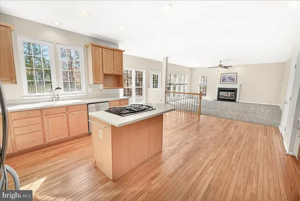 a bathroom with a granite countertop sink and a large mirror
