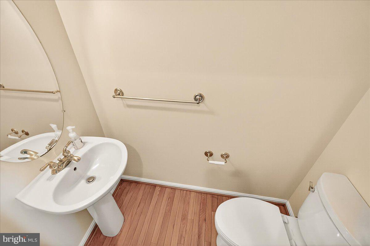 19332 Cissel Manor Drive Poolesville, MD 20837 - Photo 39 of 81 a bathroom with a sink mirror and toilet