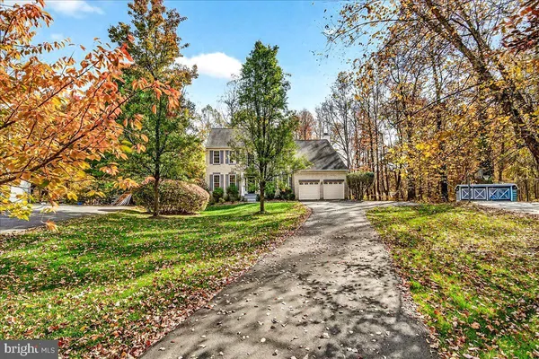 a view of a house with a yard and tree s