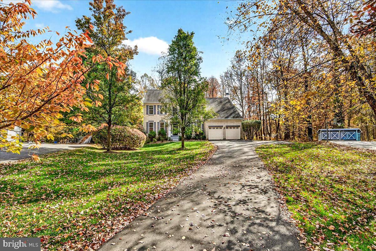 19332 Cissel Manor Drive Poolesville, MD 20837 - Photo 4 of 81 a view of a house with a yard and tree s