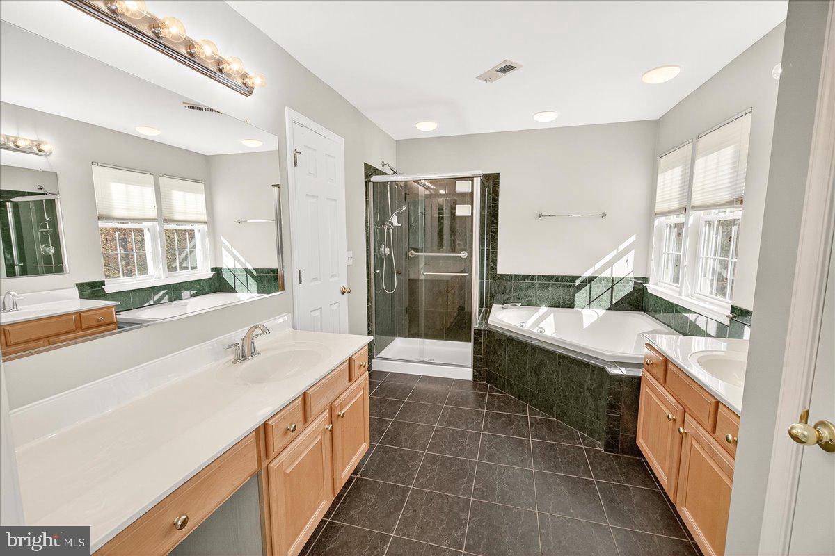 19332 Cissel Manor Drive Poolesville, MD 20837 - Photo 46 of 81 a spacious bathroom with a double vanity sink mirror and