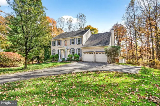 a view of a house with a yard and pathway