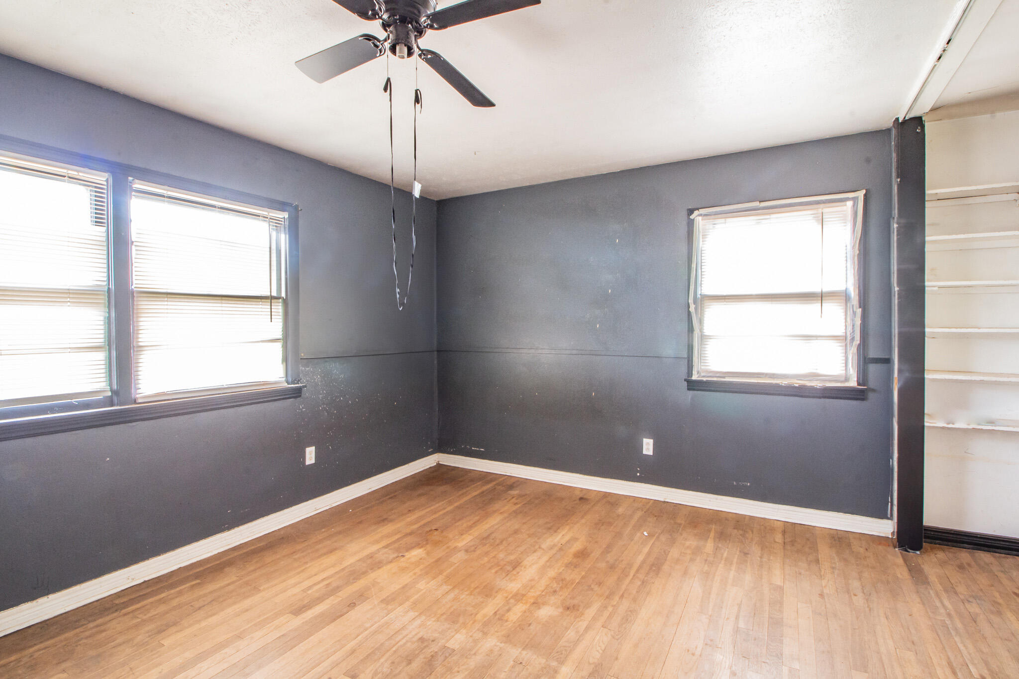 1606 60th Street Lubbock, TX 79412 - Photo 9 of 12 a view of empty room with wooden floor and fan