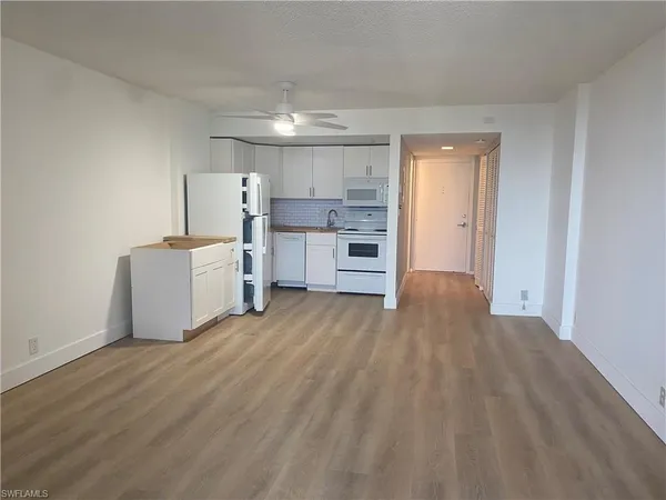 a view of kitchen with furniture and wooden floor