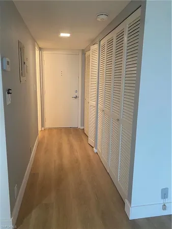 a view of hallway with wooden floor