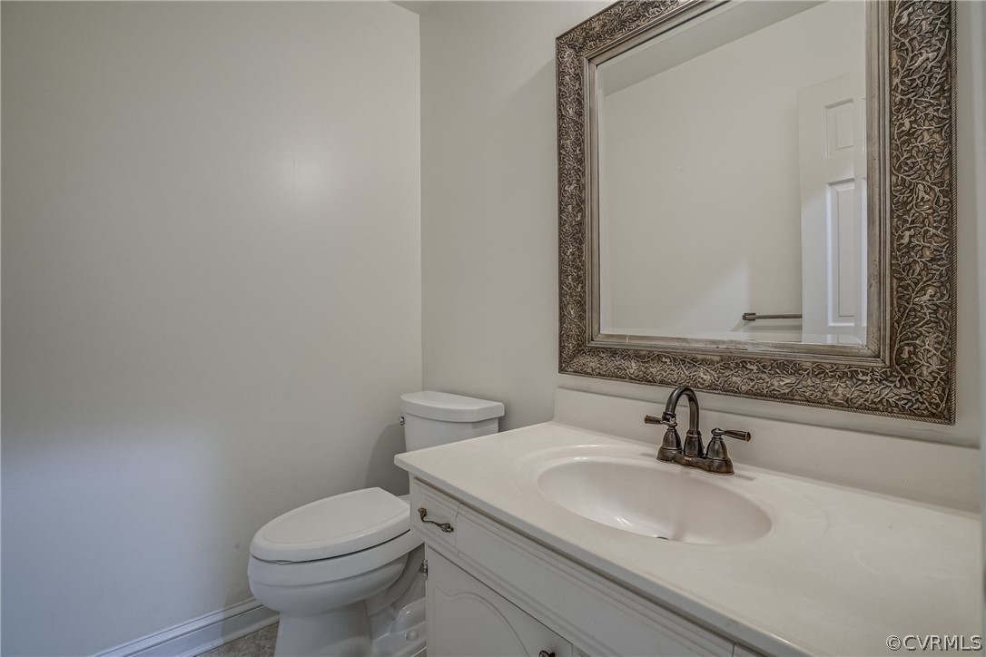 4051 Falstone Road Richmond, VA 23234 - Photo 14 of 50 a bathroom with a sink toilet and mirror