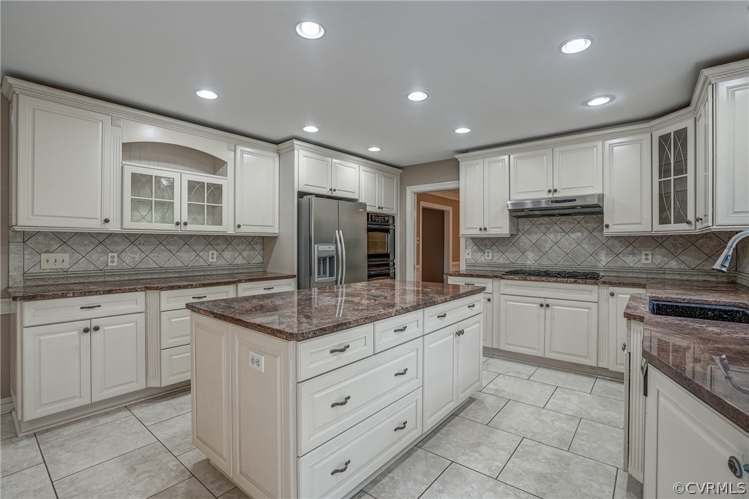 4051 Falstone Road Richmond, VA 23234 - Photo 18 of 50 a kitchen with kitchen island granite countertop white cabinets white stainless steel appliances with a sink and dishwasher