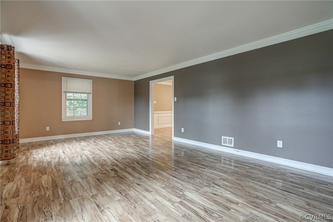 4051 Falstone Road Richmond, VA 23234 - Photo 29 of 50 a view of an empty room with window and wooden floor