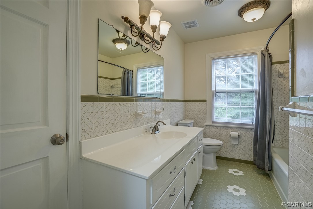 4051 Falstone Road Richmond, VA 23234 - Photo 38 of 50 a bathroom with a sink a toilet and a mirror