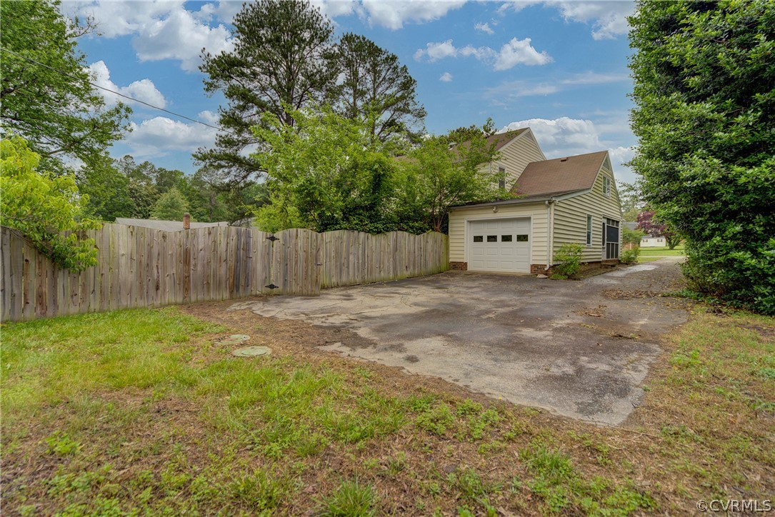 4051 Falstone Road Richmond, VA 23234 - Photo 49 of 50 a view of a backyard with large trees and wooden fence