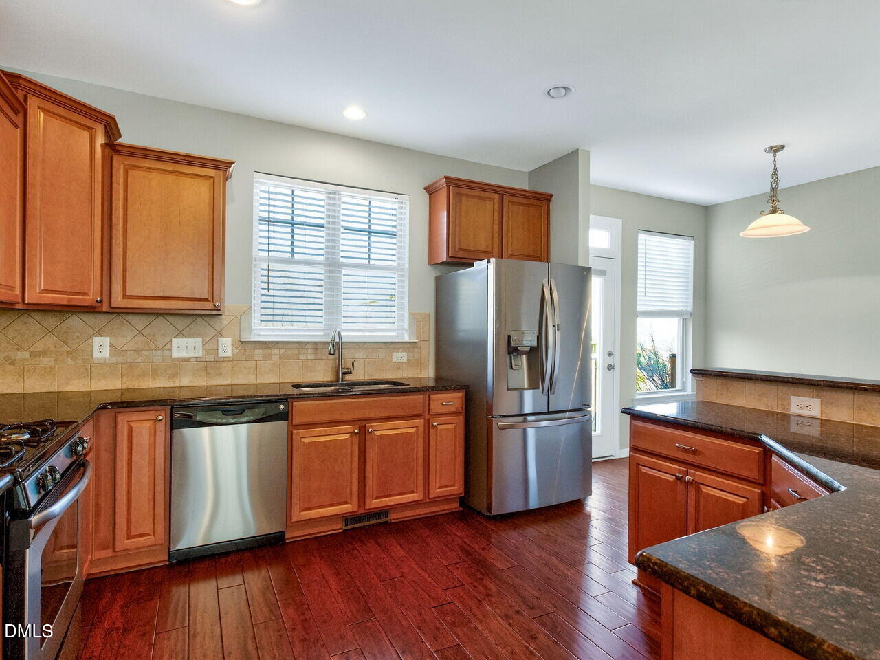 1308 Cornell Place Raleigh, NC 27607 - Photo 13 of 31 a kitchen with stainless steel appliances granite countertop a refrigerator a sink dishwasher a stove and white countertops with wooden floor