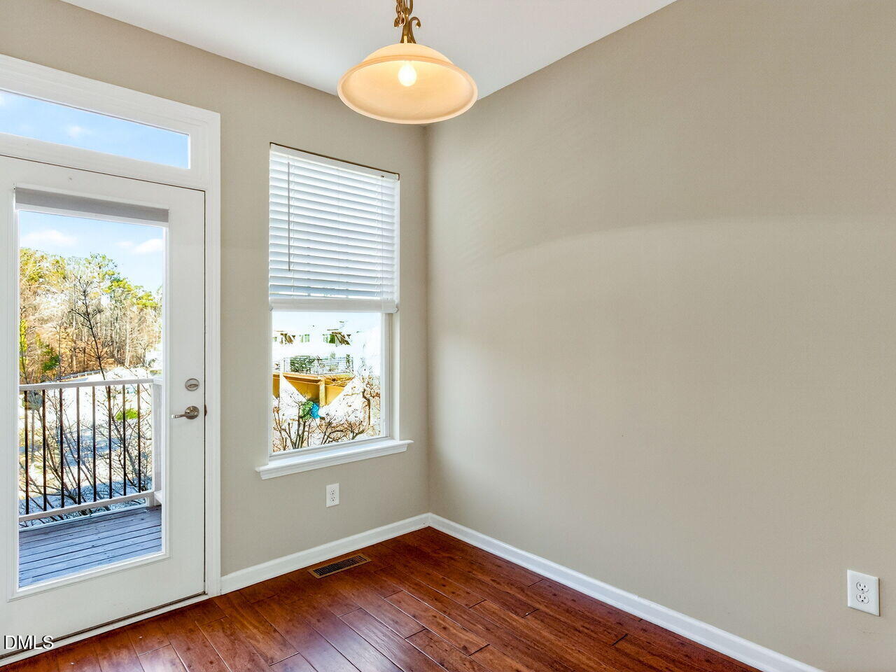 1308 Cornell Place Raleigh, NC 27607 - Photo 14 of 31 a view of an empty room with a window and wooden floor