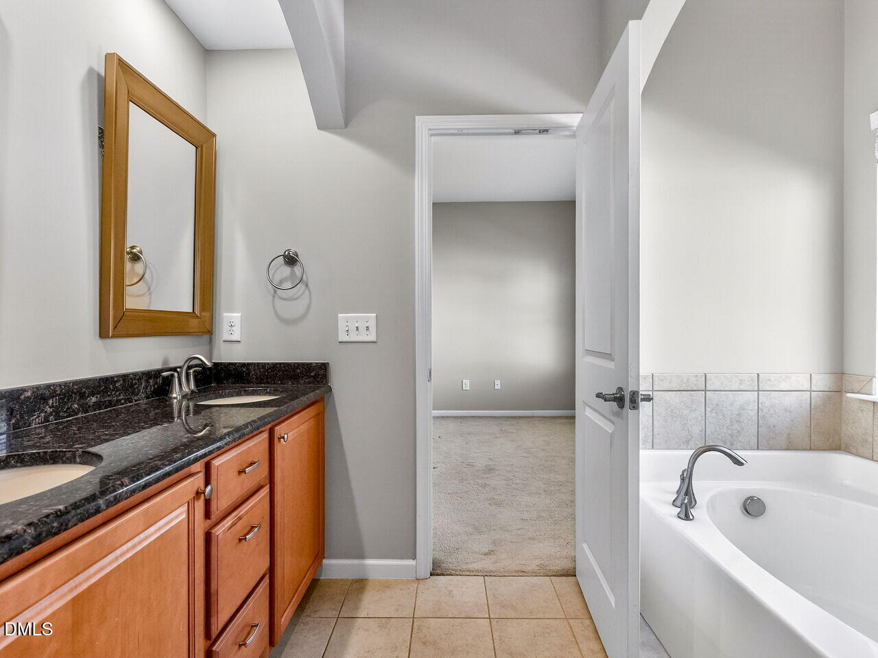 1308 Cornell Place Raleigh, NC 27607 - Photo 23 of 31 a bathroom with a tub sink and mirror