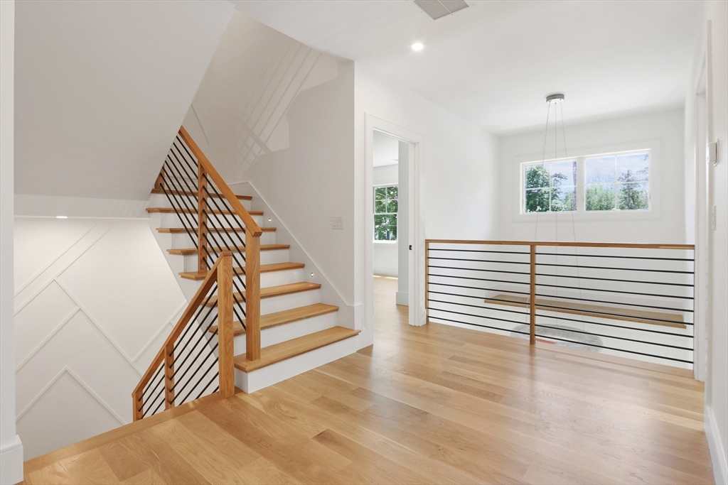 35 Mignon Road Newton, MA 02465 - Photo 19 of 42 a view of a livingroom with wooden floor and stairs