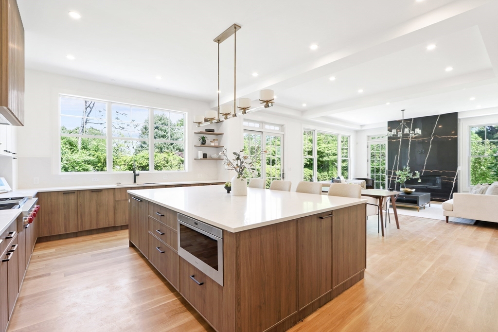 35 Mignon Road Newton, MA 02465 - Photo 8 of 42 a kitchen with kitchen island a large counter top space a sink stainless steel appliances and windows