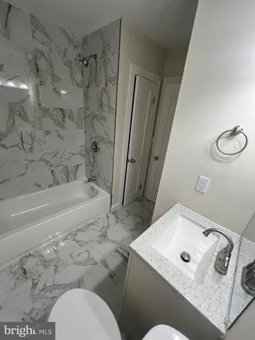 a bathroom with a bathtub and shower