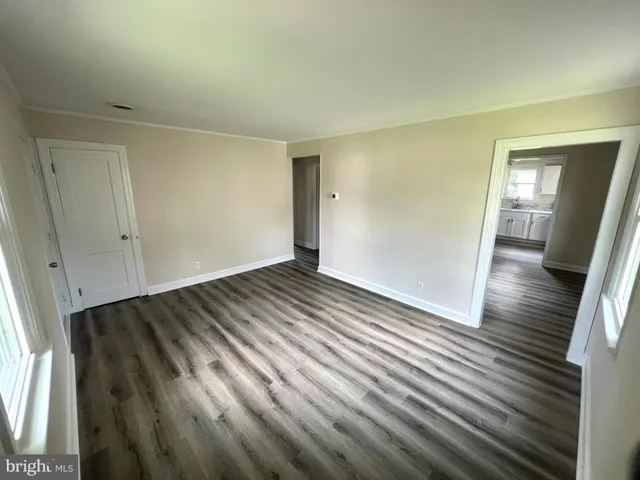 a view of a room with wooden floor