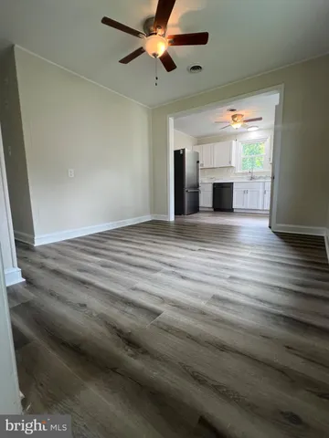 a view of empty room with fireplace and cabinet