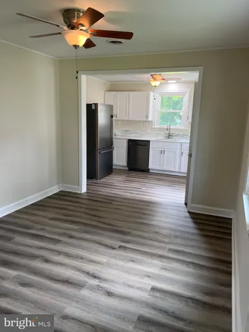 a view of an empty room with window and cabinet
