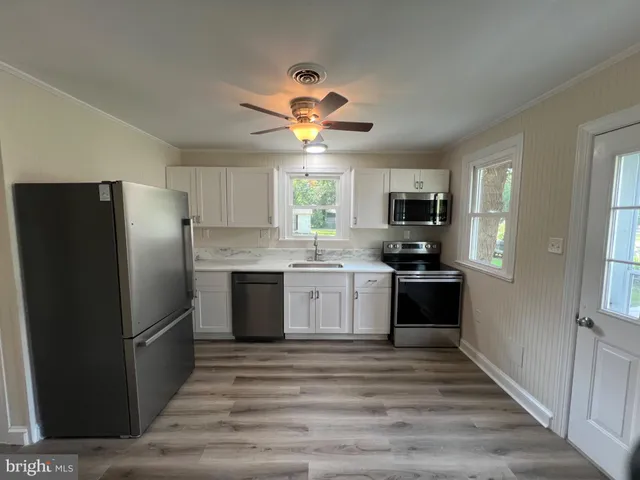 a kitchen with a refrigerator stove and microwave